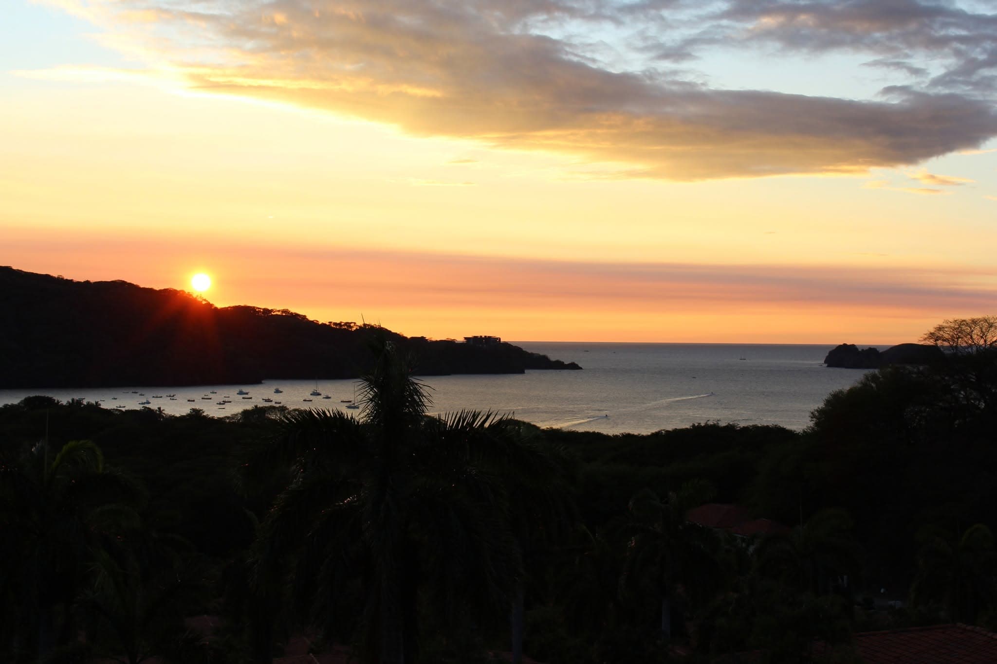 Tropical sunset over a bay full of boats